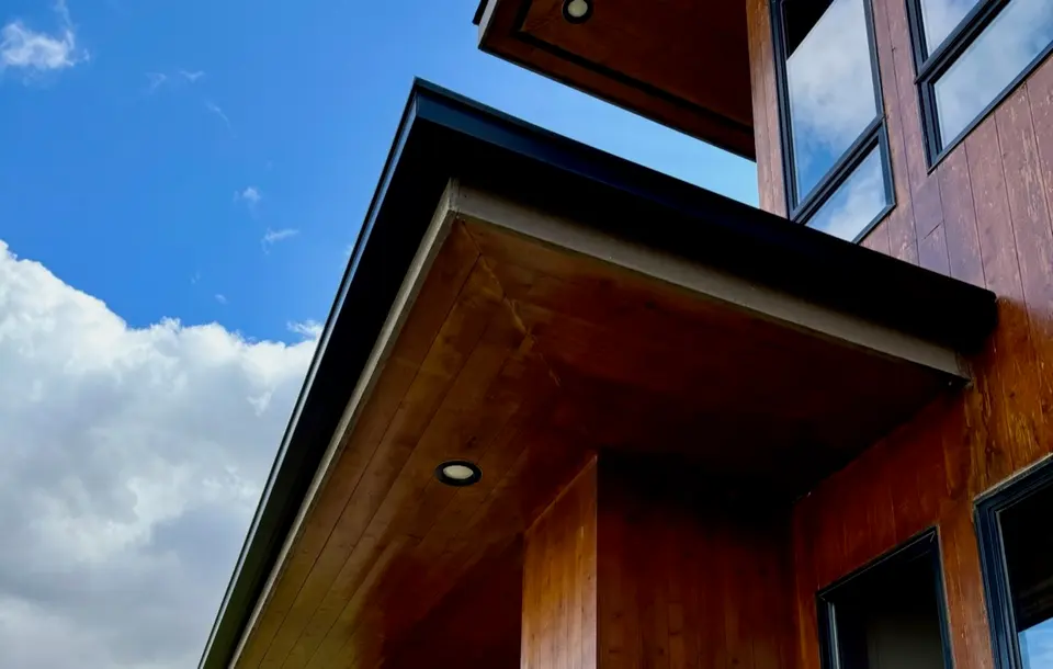 Brown seamless gutter on a residential roofline