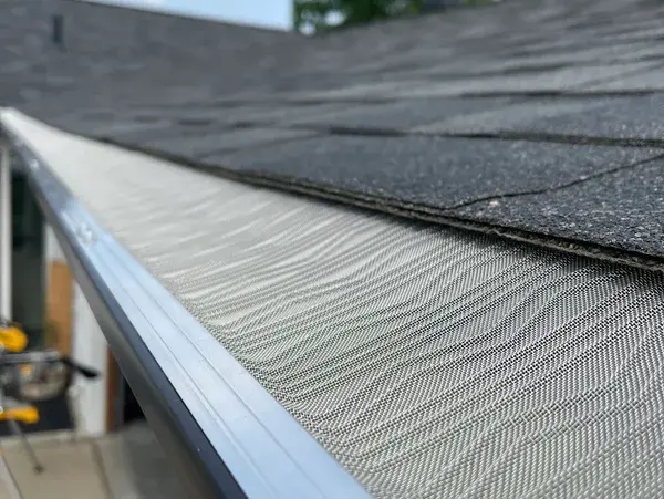 Leaf guard keeping oak and maple debris out of a gutter