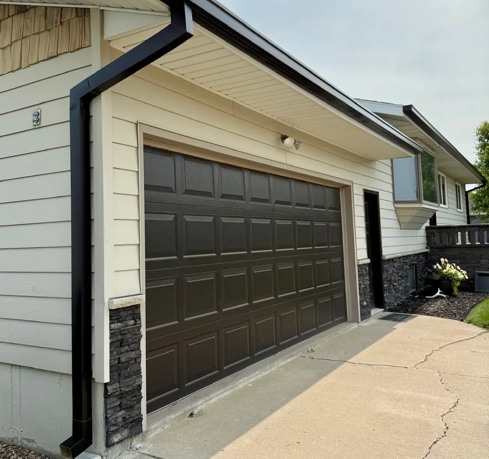 Seamless gutter and downspouts at the corner of a home