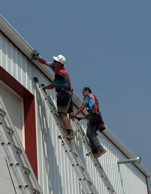 Technician servicing an installed gutter